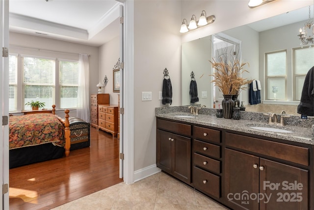 2021 Pinyon Ln, Lancaster, SC 29720 - ensuite bathroom with double vanity, baseboards, wood finished floors, and a chandelier