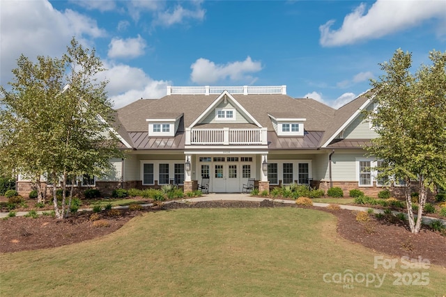 2021 Pinyon Ln, Lancaster, SC 29720 - craftsman-style home with a standing seam roof, french doors, stone siding, and a front lawn