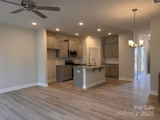 4037 Port Richmond Ave Unit 8, Gastonia, NC 28056 - kitchen featuring stainless steel appliances, a sink, a ceiling fan, gray cabinets, and tasteful backsplash