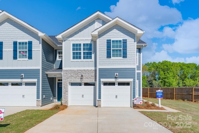 4037 Port Richmond Ave Unit 8, Gastonia, NC 28056 - view of front of property with concrete driveway, an attached garage, fence, board and batten siding, and stone siding