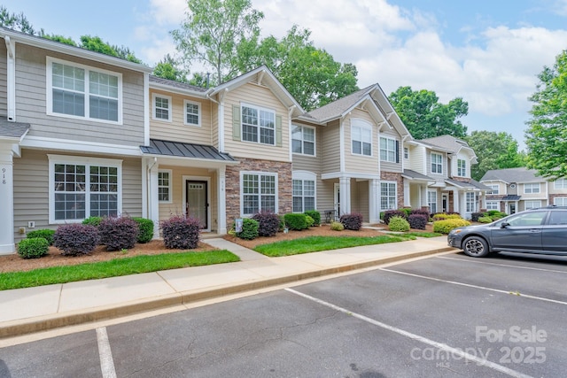 916 Coffee Tree Ln, Rock Hill, SC 29732 - townhome / multi-family property featuring uncovered parking, a standing seam roof, metal roof, a residential view, and stone siding