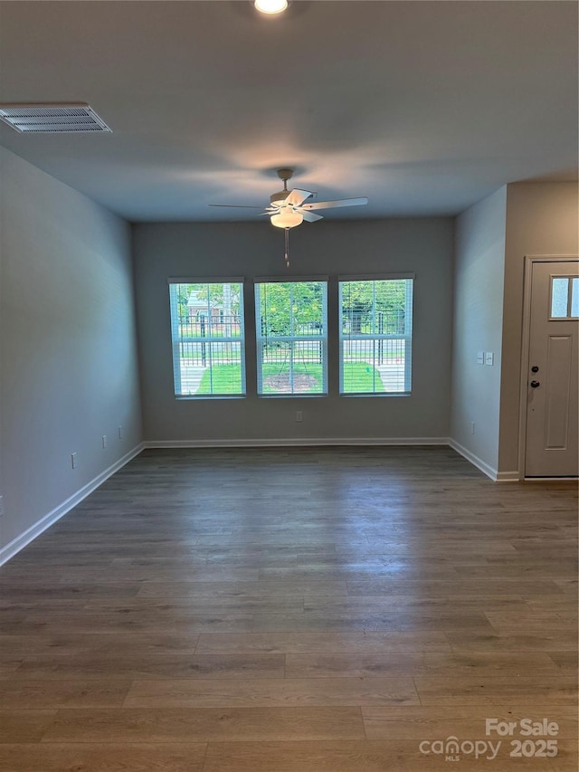 2910 Sloan Dr, Charlotte, NC 28208 - empty room with wood finished floors, baseboards, and a ceiling fan