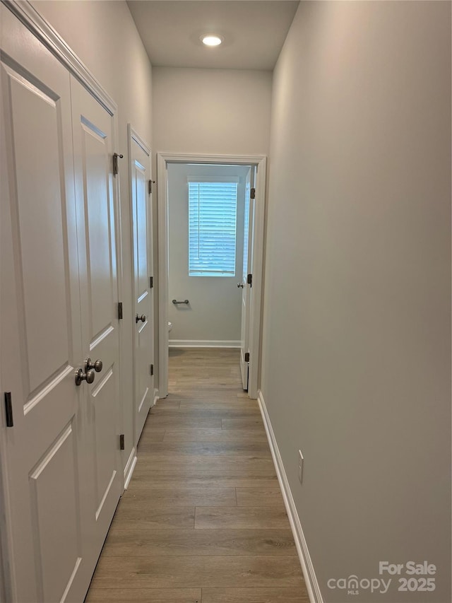 2910 Sloan Dr, Charlotte, NC 28208 - hall with light wood-type flooring, baseboards, and recessed lighting