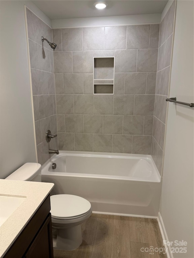 2910 Sloan Dr, Charlotte, NC 28208 - bathroom with toilet, shower / bathtub combination, vanity, and wood finished floors
