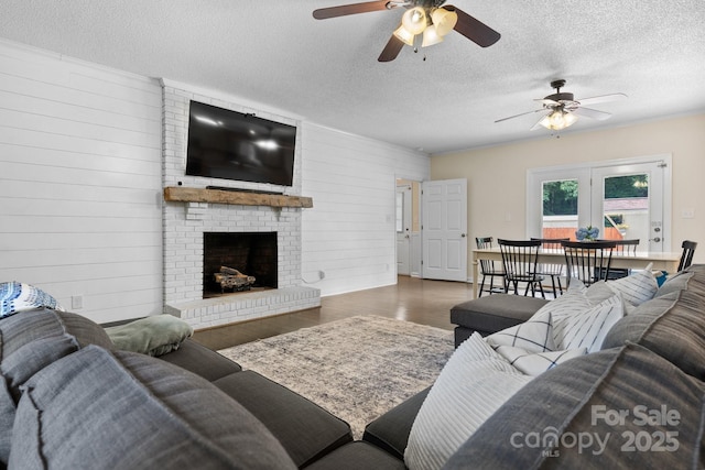 4916 Leepers Creek Rd, Maiden, NC 28650 - living area with a ceiling fan, wood finished floors, a textured ceiling, and a fireplace