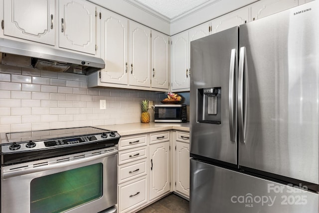 4916 Leepers Creek Rd, Maiden, NC 28650 - kitchen with stainless steel appliances, under cabinet range hood, light countertops, white cabinetry, and ornamental molding
