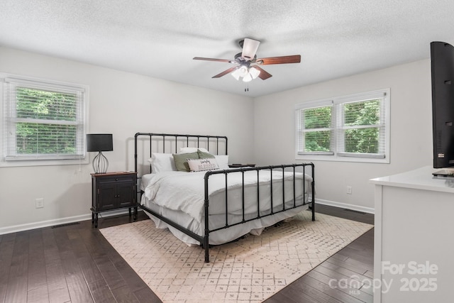 4916 Leepers Creek Rd, Maiden, NC 28650 - bedroom with baseboards, dark wood-type flooring, a textured ceiling, and a ceiling fan