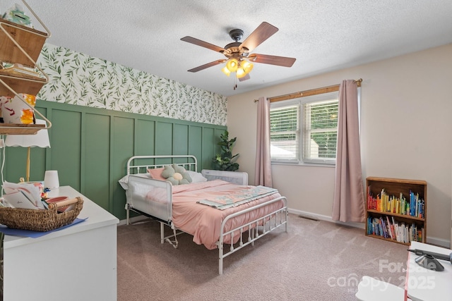 4916 Leepers Creek Rd, Maiden, NC 28650 - carpeted bedroom featuring wallpapered walls, a wainscoted wall, a textured ceiling, a decorative wall, and a ceiling fan