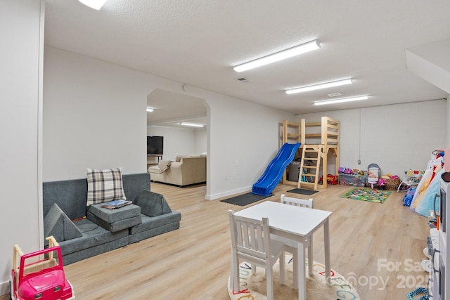 4916 Leepers Creek Rd, Maiden, NC 28650 - rec room with wood finished floors, arched walkways, and a textured ceiling