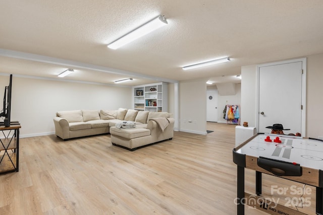 4916 Leepers Creek Rd, Maiden, NC 28650 - living area with light wood-style floors, a textured ceiling, and baseboards