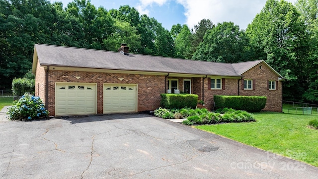 4916 Leepers Creek Rd, Maiden, NC 28650 - single story home with an attached garage, asphalt driveway, brick siding, a shingled roof, and a chimney