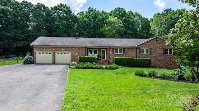 4916 Leepers Creek Rd, Maiden, NC 28650 - ranch-style home with asphalt driveway, a garage, brick siding, a front yard, and a chimney