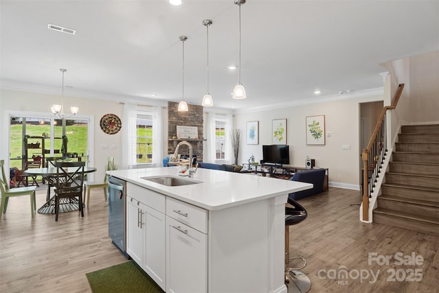 107 Hornbeam Ln, Mooresville, NC 28117 - kitchen with a sink, dishwasher, crown molding, light wood-style flooring, and open floor plan