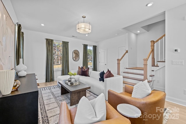 living area featuring wood finished floors, stairway, recessed lighting, and baseboards
