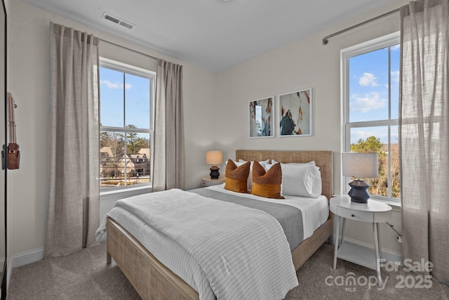 carpeted bedroom featuring baseboards