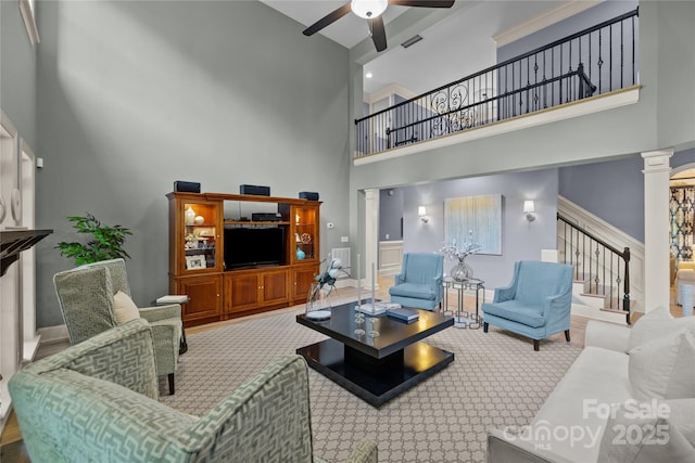 9021 Unbridle Ln, Waxhaw, NC 28173 - carpeted living area with a high ceiling, stairway, ceiling fan, decorative columns, and baseboards