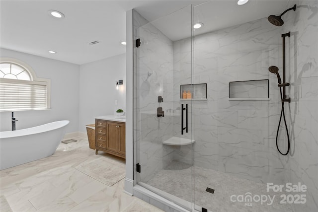 9021 Unbridle Ln, Waxhaw, NC 28173 - full bath with marble finish flooring, a marble finish shower, recessed lighting, vanity, and a freestanding bath