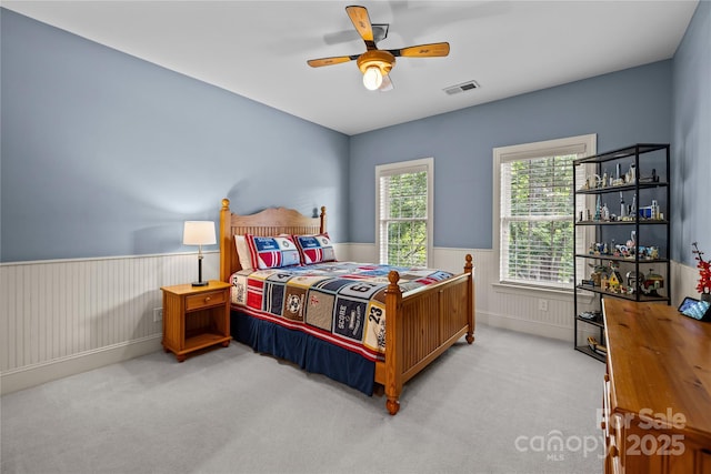 9021 Unbridle Ln, Waxhaw, NC 28173 - carpeted bedroom with wainscoting and ceiling fan