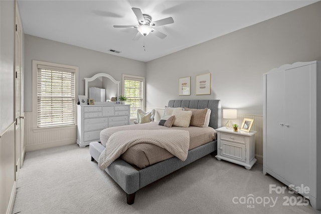 9021 Unbridle Ln, Waxhaw, NC 28173 - bedroom featuring light carpet, a wainscoted wall, and a ceiling fan