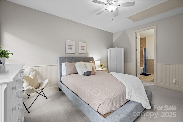 9021 Unbridle Ln, Waxhaw, NC 28173 - bedroom featuring light colored carpet, wainscoting, attic access, ensuite bathroom, and a ceiling fan