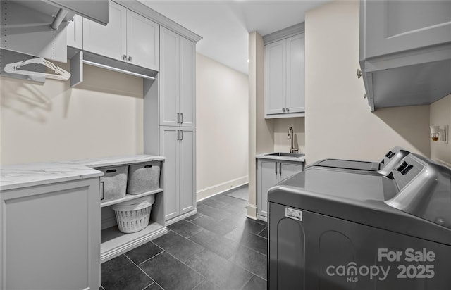 9021 Unbridle Ln, Waxhaw, NC 28173 - laundry room featuring cabinet space, washing machine and dryer, and baseboards
