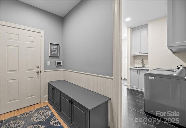 9021 Unbridle Ln, Waxhaw, NC 28173 - mudroom with a sink, a wainscoted wall, wood finished floors, washing machine and dryer, and recessed lighting