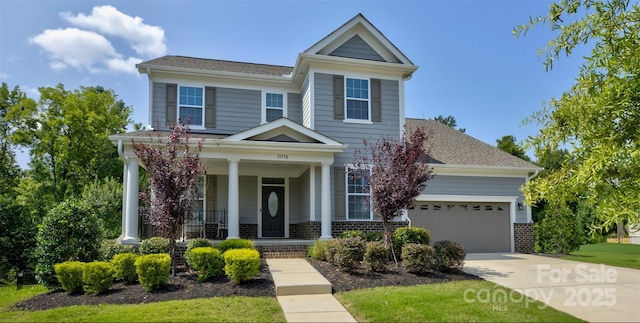 11718 Preservation Ln, Charlotte, NC 28278 - view of front facade featuring a porch, a garage, driveway, brick siding, and roof with shingles
