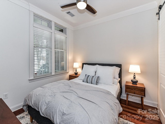 2810 Selwyn Ave Unit 104, Charlotte, NC 28209 - bedroom featuring wood finished floors, crown molding, baseboards, and a ceiling fan