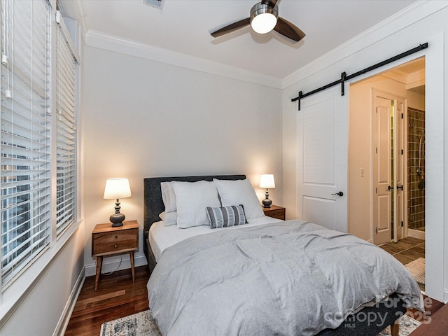 2810 Selwyn Ave Unit 104, Charlotte, NC 28209 - bedroom with ornamental molding, a barn door, baseboards, wood finished floors, and a ceiling fan