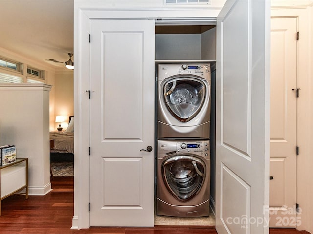 2810 Selwyn Ave Unit 104, Charlotte, NC 28209 - laundry room with stacked washing machine and dryer, wood finished floors, and baseboards