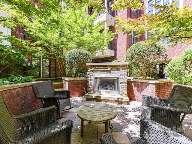 2810 Selwyn Ave Unit 104, Charlotte, NC 28209 - view of patio / terrace featuring an outdoor stone fireplace
