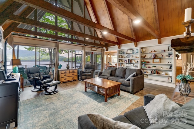 214 Sequoyah Trl, Robbinsville, NC 28771 - living room featuring plenty of natural light, beam ceiling, high vaulted ceiling, and wood finished floors