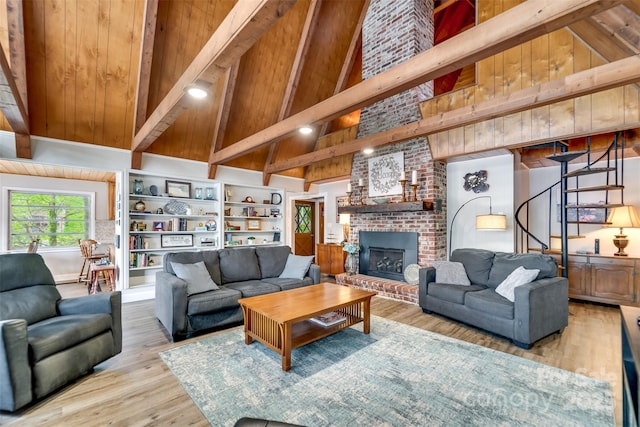 214 Sequoyah Trl, Robbinsville, NC 28771 - living area featuring beamed ceiling, stairway, wood finished floors, high vaulted ceiling, and a fireplace