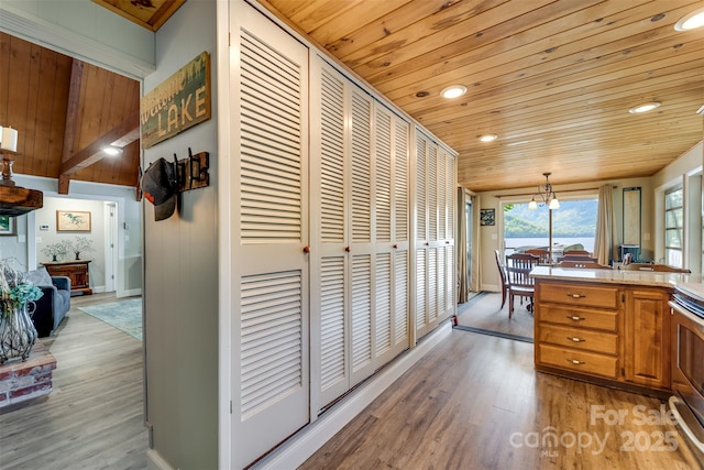 214 Sequoyah Trl, Robbinsville, NC 28771 - kitchen with wood ceiling, recessed lighting, light wood-type flooring, a chandelier, and light countertops