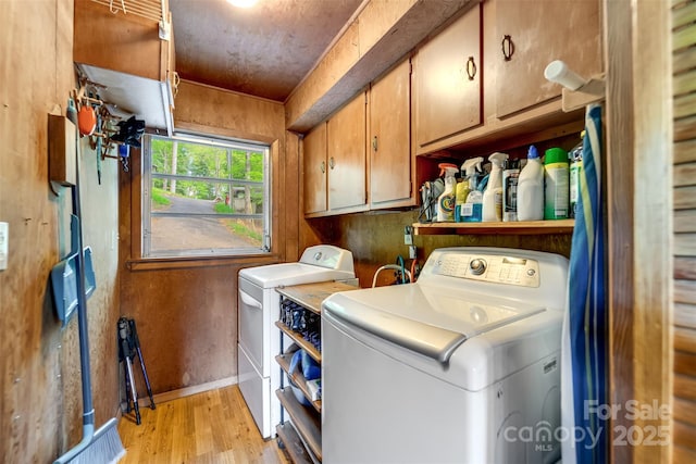 214 Sequoyah Trl, Robbinsville, NC 28771 - washroom featuring cabinet space, washer and clothes dryer, light wood finished floors, and baseboards