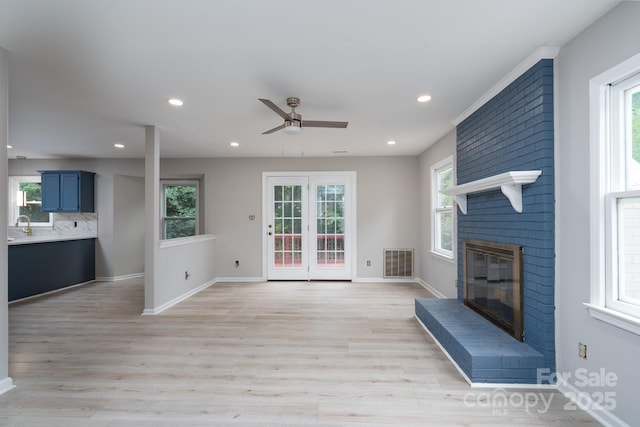1013 Doby Springs Dr, Charlotte, NC 28262 - unfurnished living room with a ceiling fan, light wood-style floors, healthy amount of natural light, and recessed lighting