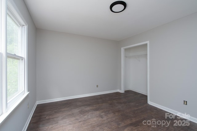 1013 Doby Springs Dr, Charlotte, NC 28262 - unfurnished bedroom with dark wood-style flooring, baseboards, and a closet
