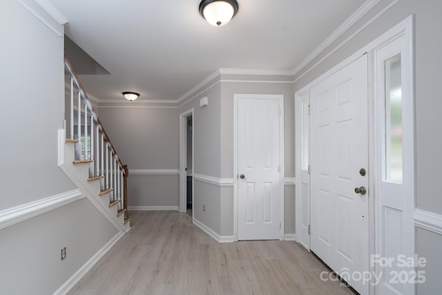 1013 Doby Springs Dr, Charlotte, NC 28262 - foyer with wood finished floors, stairway, crown molding, and baseboards