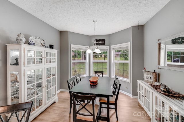 592 Woodcrest Dr, Gastonia, NC 28052 - dining space with light wood-style flooring, plenty of natural light, a textured ceiling, and baseboards