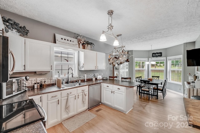 592 Woodcrest Dr, Gastonia, NC 28052 - kitchen featuring dishwasher, electric stove, a sink, a textured ceiling, and light wood-type flooring