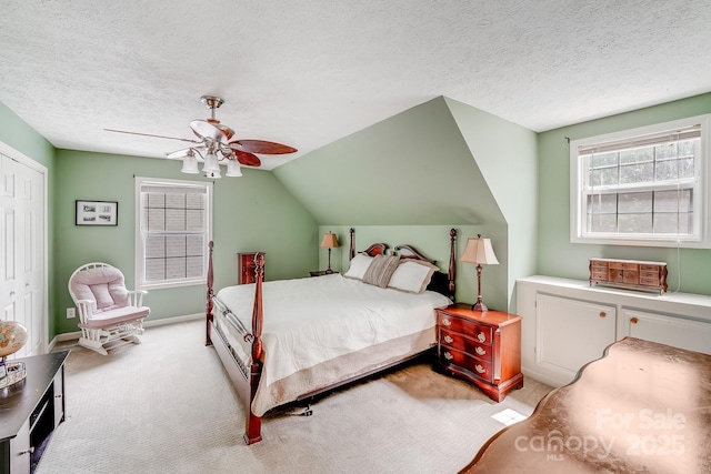 592 Woodcrest Dr, Gastonia, NC 28052 - bedroom with light carpet, a closet, a ceiling fan, a textured ceiling, and vaulted ceiling