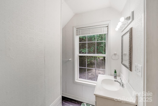 592 Woodcrest Dr, Gastonia, NC 28052 - bathroom featuring lofted ceiling, vanity, and wood finished floors