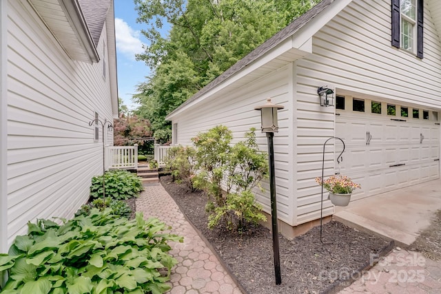 592 Woodcrest Dr, Gastonia, NC 28052 - view of side of home with roof with shingles and an attached garage
