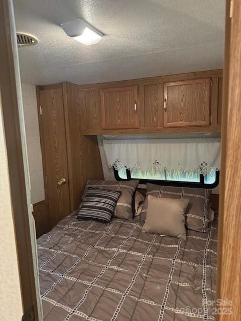 bedroom with a textured ceiling and carpet