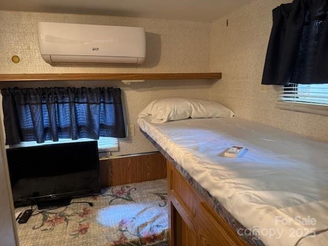 bedroom featuring a wall mounted AC