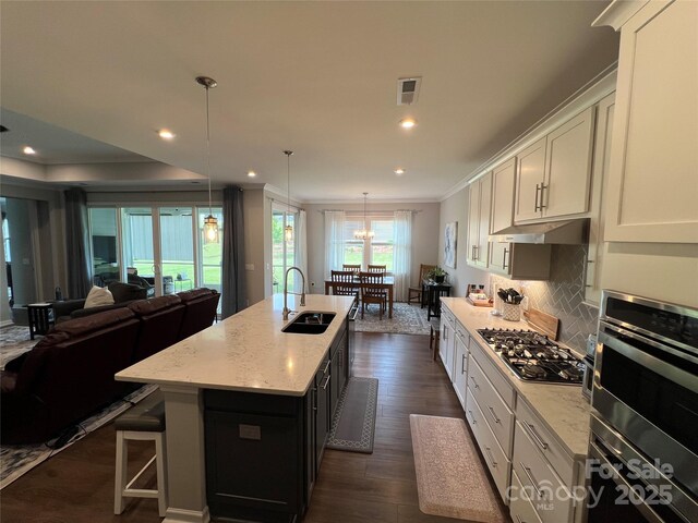 7057 Kingfisher Way, Belmont, NC 28012 - kitchen featuring a sink, stainless steel appliances, open floor plan, ornamental molding, and tasteful backsplash