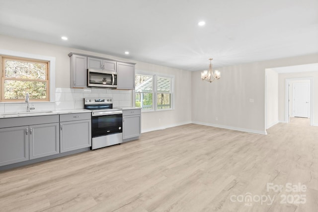 174 Maske Rd, Mount Gilead, NC 27306 - kitchen with stainless steel appliances, gray cabinets, a sink, a chandelier, and light countertops
