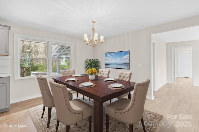 174 Maske Rd, Mount Gilead, NC 27306 - dining space featuring a chandelier, light wood finished floors, and baseboards