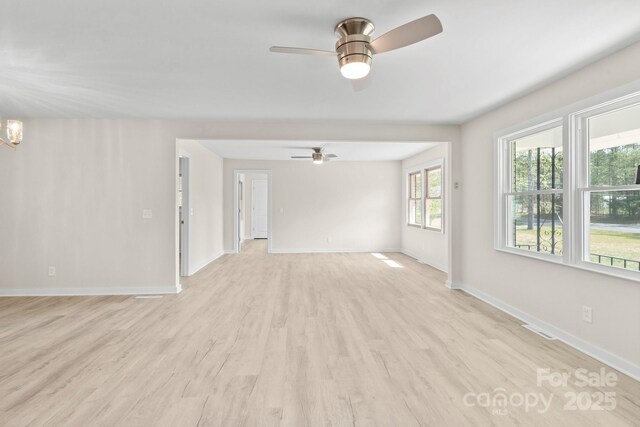 174 Maske Rd, Mount Gilead, NC 27306 - unfurnished room with ceiling fan, baseboards, light wood-style floors, and a chandelier