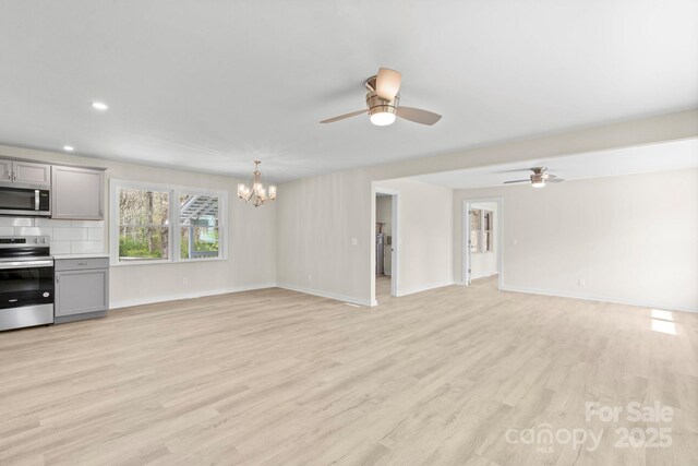 174 Maske Rd, Mount Gilead, NC 27306 - unfurnished living room featuring ceiling fan, a chandelier, light wood-style floors, baseboards, and recessed lighting
